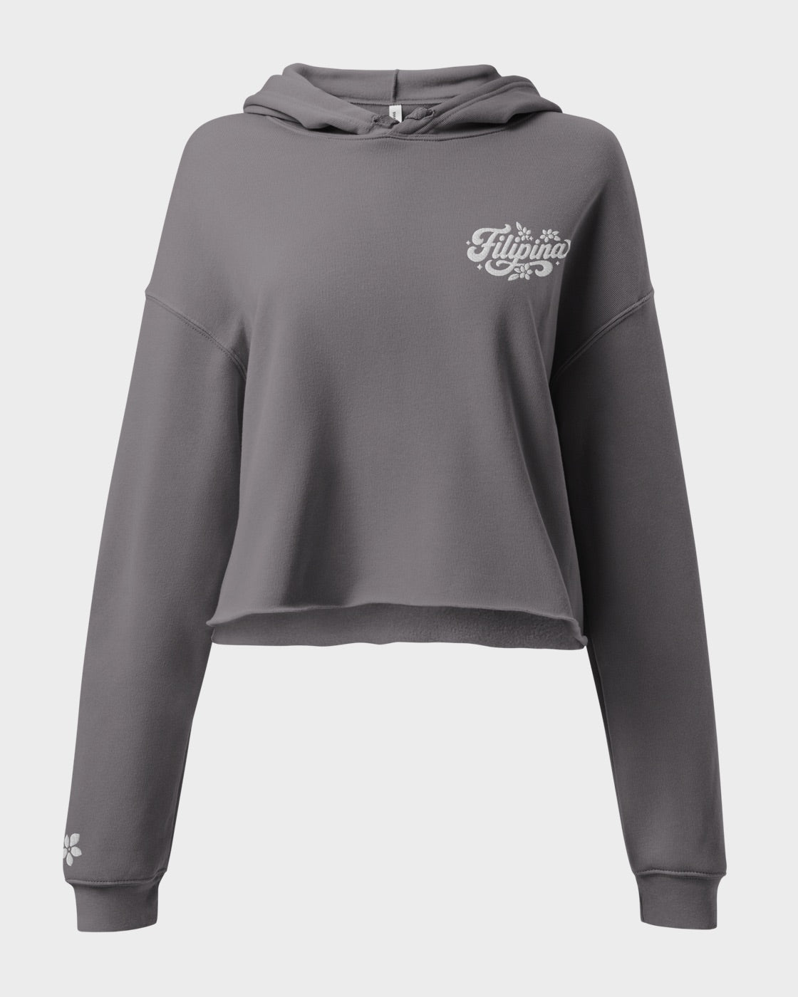 A dark gray cropped hoodie sweatshirt with a white 'Filipina' graphic on the left chest and a small white flower on the sleeve cuff, shown against a light gray background.