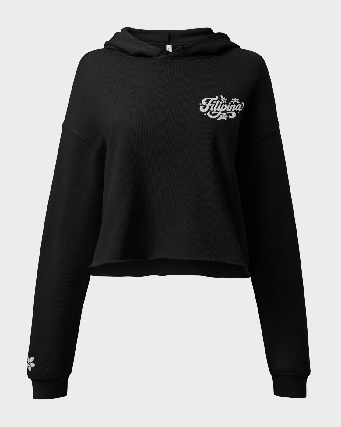 A black cropped hoodie sweatshirt with a white cursive 'Filipina' graphic on the left chest and a small white graphic on the right sleeve cuff, displayed on a neutral light gray background.