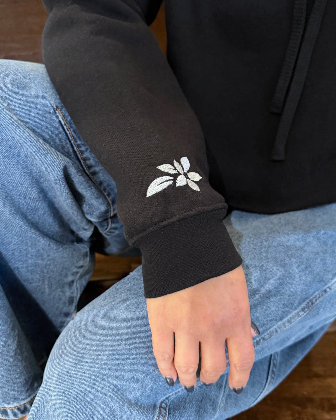Close-up of the right sleeve with a white embroidered sampaguita flower on the wrist.