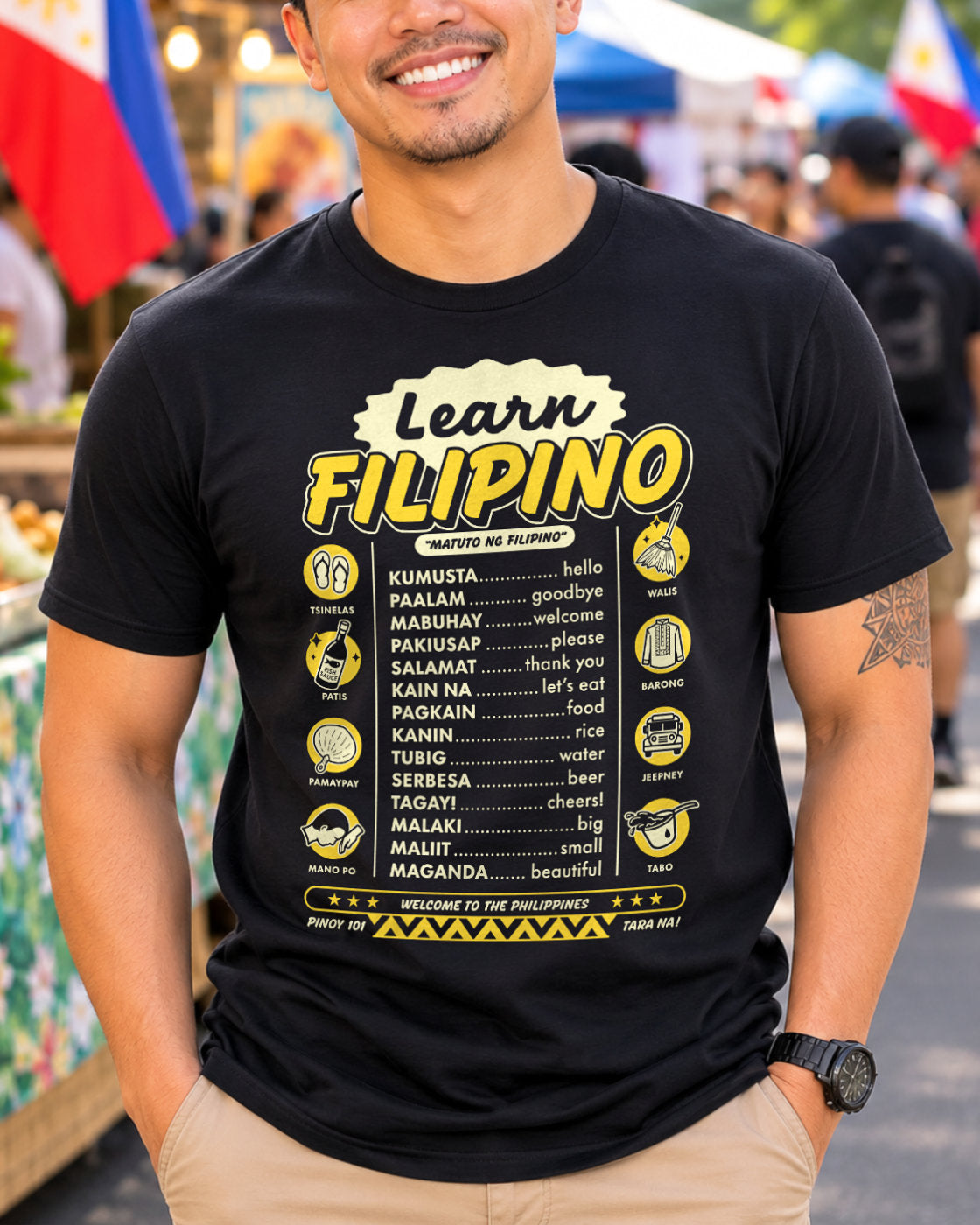 Filipino man wearing a black t-shirt with 'Learn Filipino' text and graphics in an outdoor setting.