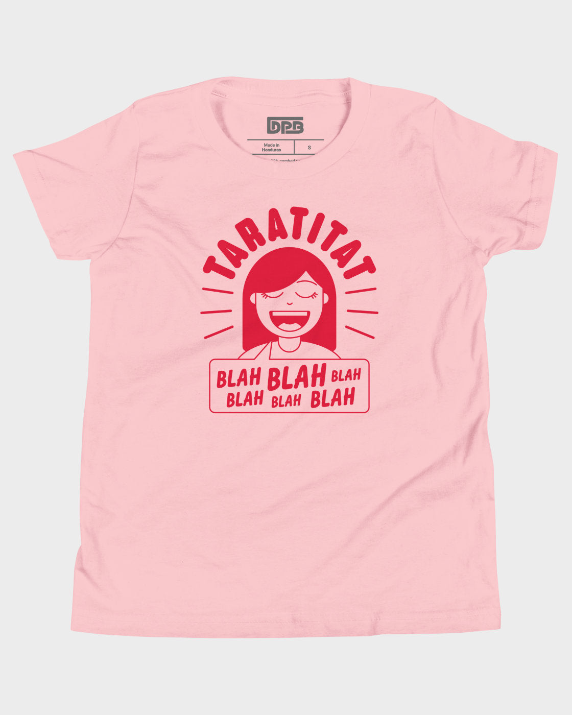 A light pink short-sleeve t-shirt with a red graphic print on the front. The graphic features the word 'TARATITAT' in arched red letters above a cartoon character with red hair and a speech bubble that reads 'BLAH BLAH BLAH BLAH BLAH BLAH'.
